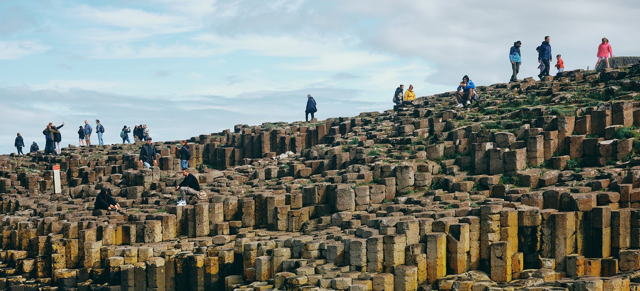 people exploring Giants Causeway